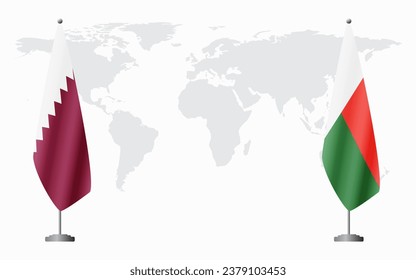  Qatar and Madagascar flags for official meeting against background of world map.