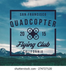 quadcopter flying club emblem on mountain landscape background