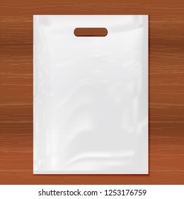 Quality Plastic Bag on wooden background,white plastic bag.Realistic Shopping Bag for branding and corporate identity design.Vector set mock up.