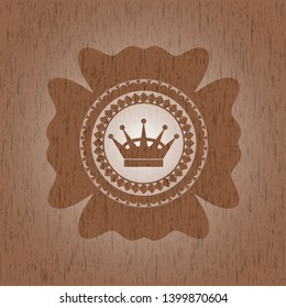 queen crown icon inside badge with wood background