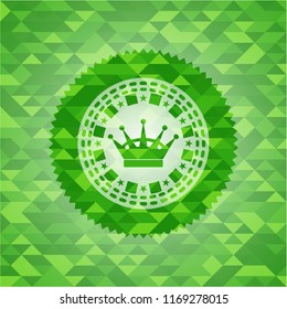 queen crown icon inside green emblem with triangle mosaic background