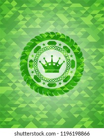 queen crown icon inside green emblem. Mosaic background