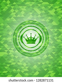 queen crown icon inside green mosaic emblem