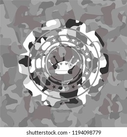 queen crown icon inside grey camouflaged emblem