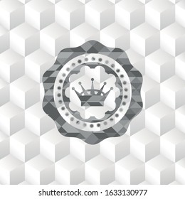 queen crown icon inside grey emblem with geometric cube white background