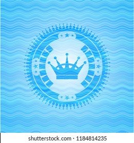 queen crown icon inside light blue water style badge.