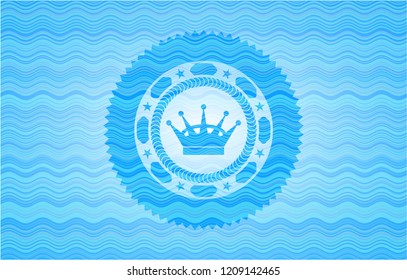 queen crown icon inside light blue water style badge.