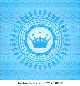 queen crown icon inside sky blue water emblem background.
