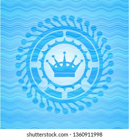 queen crown icon inside sky blue water emblem background.