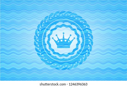 queen crown icon inside water wave badge background.