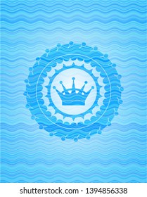 queen crown icon inside water style emblem.