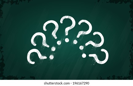 Question marks hand drawn on green chalkboard