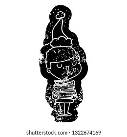 quirky cartoon distressed icon of a happy boy with stack of books wearing santa hat