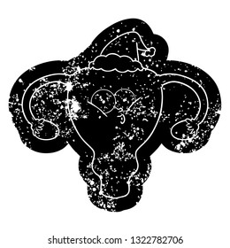 quirky cartoon distressed icon of a uterus wearing santa hat