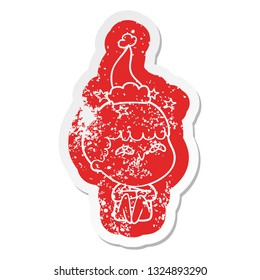 quirky cartoon distressed sticker of a amazed boy wearing santa hat
