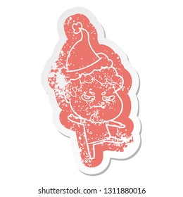 quirky cartoon distressed sticker of a angry man wearing santa hat