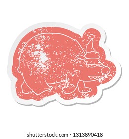 quirky cartoon distressed sticker of a angry polar bear wearing santa hat