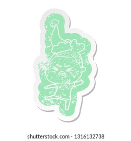 quirky cartoon distressed sticker of a angry woman wearing santa hat