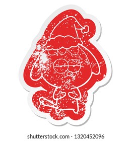 quirky cartoon distressed sticker of a bored dog wearing santa hat