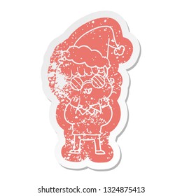 quirky cartoon distressed sticker of a boy wearing spectacles wearing santa hat