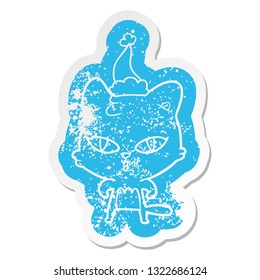 quirky cartoon distressed sticker of a cat wearing santa hat