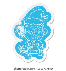 quirky cartoon distressed sticker of a christmas monkey wearing santa hat