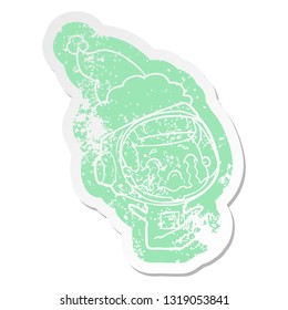 quirky cartoon distressed sticker of a crying astronaut wearing santa hat