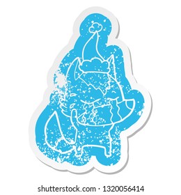 quirky cartoon distressed sticker of a crying wolf wearing santa hat