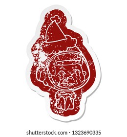 quirky cartoon distressed sticker of a crying astronaut wearing santa hat