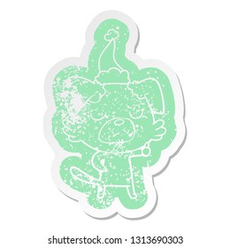 quirky cartoon distressed sticker of a dog wearing santa hat
