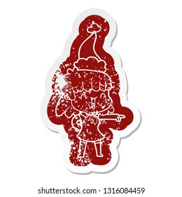 quirky cartoon distressed sticker of a happy girl wearing santa hat
