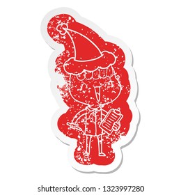 quirky cartoon distressed sticker of a happy boy surprised wearing santa hat