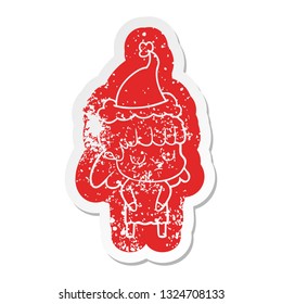 quirky cartoon distressed sticker of a indifferent woman wearing santa hat