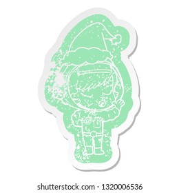 quirky cartoon distressed sticker of a pretty astronaut girl wearing santa hat