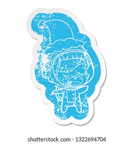 quirky cartoon distressed sticker of a talking astronaut woman wearing santa hat