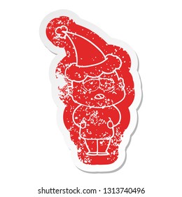 quirky cartoon distressed sticker of a tired bald man wearing santa hat