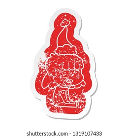 quirky cartoon distressed sticker of a tired woman wearing santa hat