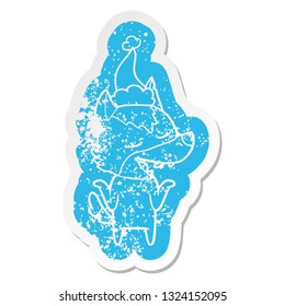 quirky cartoon distressed sticker of a wolf laughing wearing santa hat