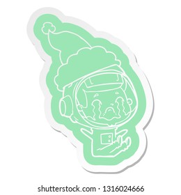 quirky cartoon  sticker of a crying astronaut wearing santa hat