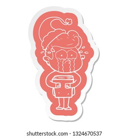quirky cartoon  sticker of a crying man holding book wearing santa hat