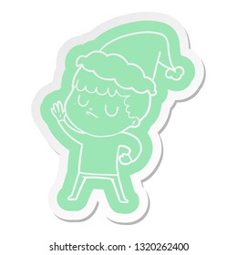 quirky cartoon  sticker of a grumpy boy wearing santa hat