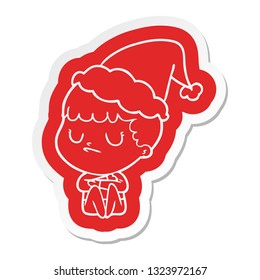 quirky cartoon  sticker of a grumpy boy wearing santa hat