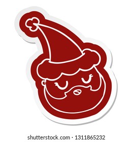 quirky cartoon  sticker of a male face with beard wearing santa hat