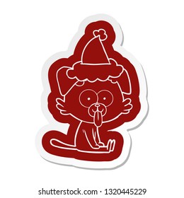 quirky cartoon  sticker of a sitting dog with tongue sticking out wearing santa hat