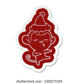 quirky cartoon  sticker of a suspicious monkey wearing santa hat