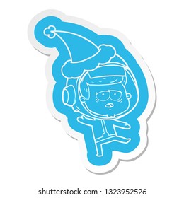 quirky cartoon  sticker of a tired astronaut wearing santa hat