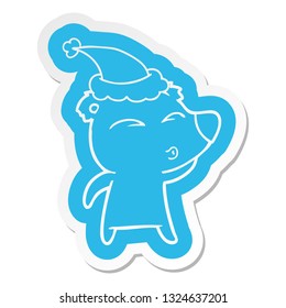 quirky cartoon  sticker of a whistling bear wearing santa hat