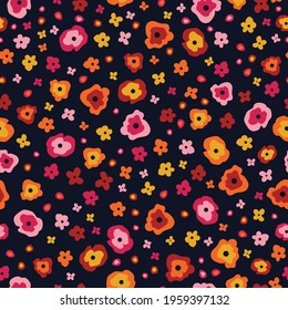 Quirky floral design with bright, cute, colourful, fun, pink, yellow, orange and red abstract flowers on a navy blue background. Seamless vector illustrated repeat pattern for fall and autumn season. 