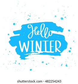 Quote Hello Winter. The trend calligraphy. Vector illustration on white background with a smear of ink blue. Great holiday gift card.