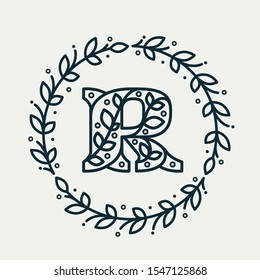 R letter logo consisting of floral pattern in a circle laurel wreath. Linear heraldic vector font. Can be used for boutique, cafe, restaurant, royalty, hotel, jewelry or sport industry.